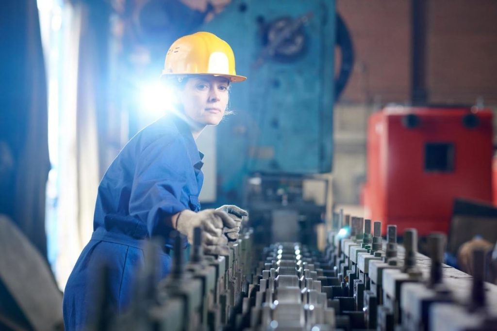 Millwright verifying conveyor in an industrial plant