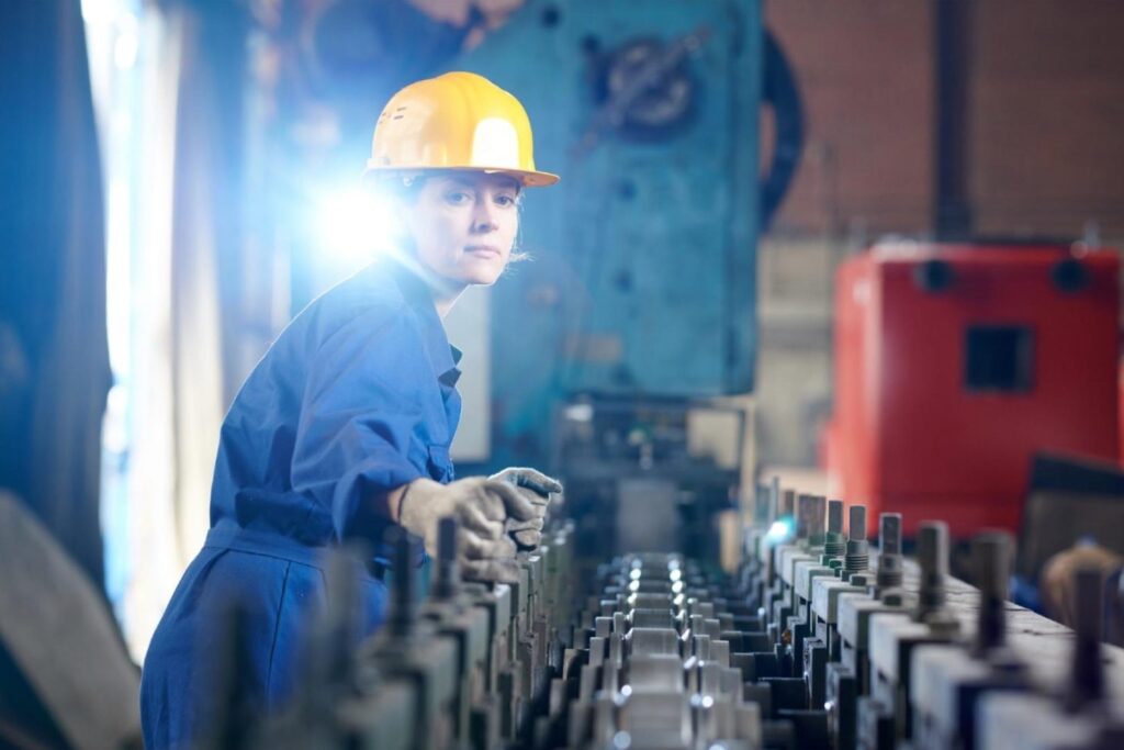 Millwright verifying conveyor in an industrial plant