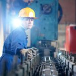 Millwright verifying conveyor in an industrial plant