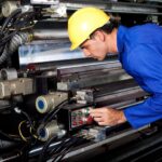 Millwright verifying conveyor in an industrial plant