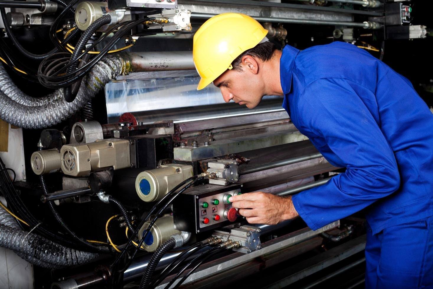 Millwright verifying conveyor in an industrial plant